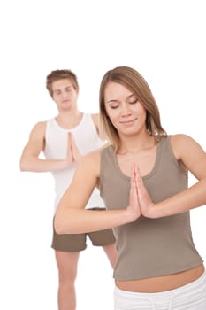 Fitness - Young healthy couple in yoga position on white background