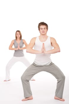 Fitness - Young healthy couple in yoga position on white background