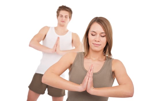 Fitness - Young healthy couple in yoga position on white background
