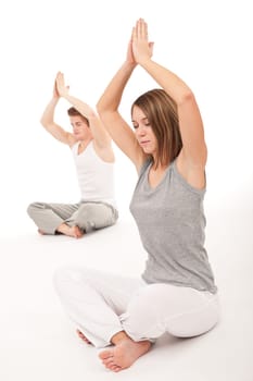Fitness - Young healthy couple in yoga position on white background