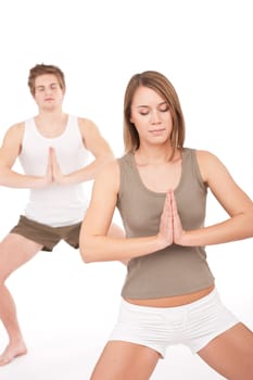 Fitness - Young healthy couple in yoga position on white background