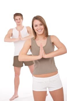 Fitness - Young healthy couple in yoga position on white background