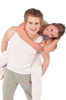 Piggyback - Young sportive smiling couple wearing fitness clothes on white background