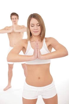 Fitness - Healthy couple stretching in yoga position on white background
