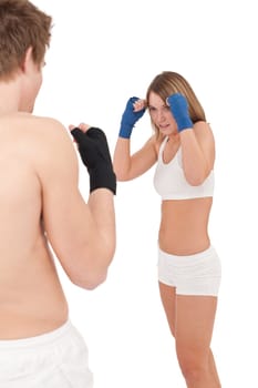 Boxing - Young woman in class training with instructor on white, hands with handwraps