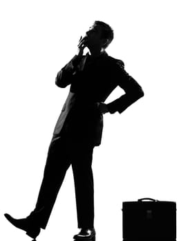 silhouette caucasian business man thinking pensive behavior  looiking up full length on studio isolated white background