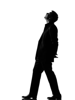 silhouette caucasian business man  walking musing looking up expressing behavior full length on studio isolated white background