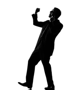 silhouette caucasian business man  expressing winning on the phone behavior full length on studio isolated white background