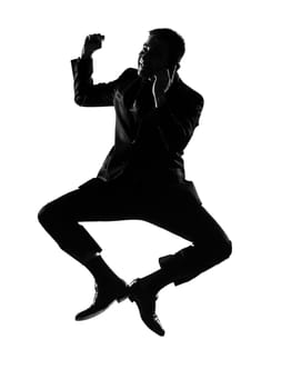silhouette caucasian business man  expressing winning jumping on the phonebehavior full length on studio isolated white background