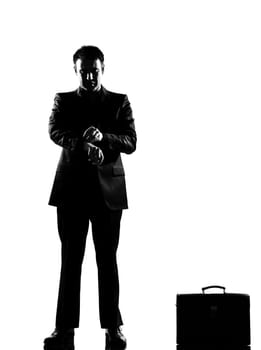 silhouette caucasian business man  waiting checking the time full length on studio isolated white background