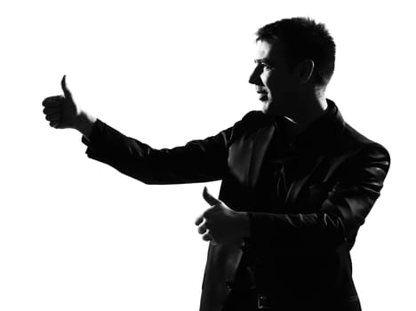 silhouette caucasian business man thumbs up  expressing winning behavior full length on studio isolated white background