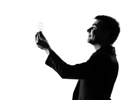 silhouette caucasian business man  holding light bulb expressing behavior full length on studio isolated white background