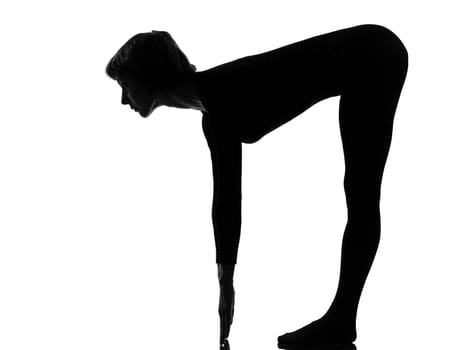 woman sun salutation yoga surya namaskar posture position in silouhette on studio white background full length