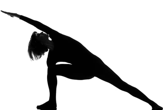 woman yoga posture Extended Side Angle Pose position in silouhette on studio white background