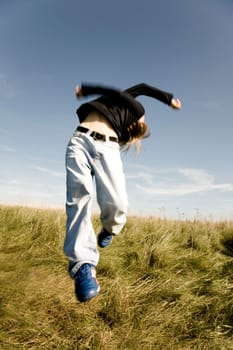 Boy jumps in the air