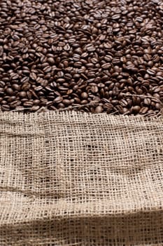 Freshly roasted coffee beans in a large canvas bag