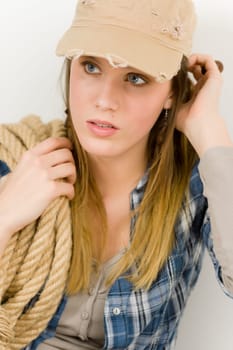 Fashion model - young woman country style posing with rope