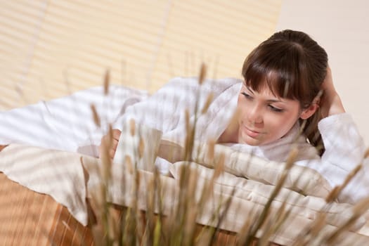 Spa - Young woman at wellness therapy relaxing after massage