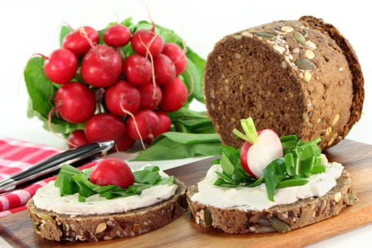 a slice of bread topped with cream cheese and fresh wild garlic