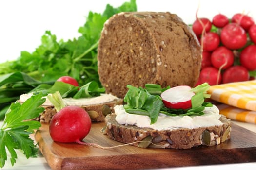 a slice of bread topped with cream cheese and fresh wild garlic