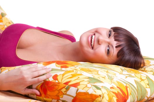 Young woman lay on color pillow and smile