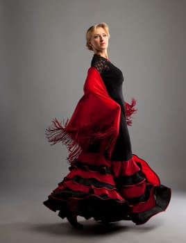 Beauty woman dance flamenco in black and red costume