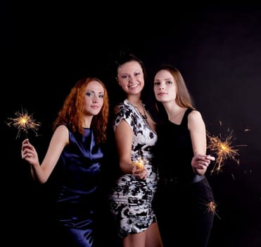 Three young woman smile with bengal light