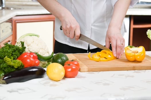 beautiful woman prepares food in the kitchen