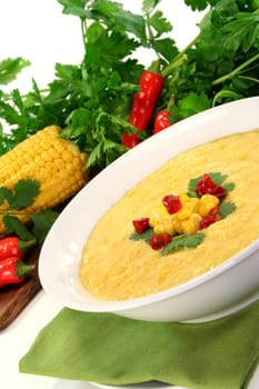 a bowl of corn soup with chili and coriander