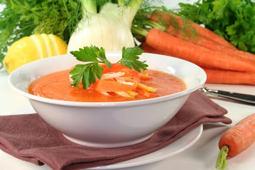 a bowl of carrot soup with fennel and lemon
