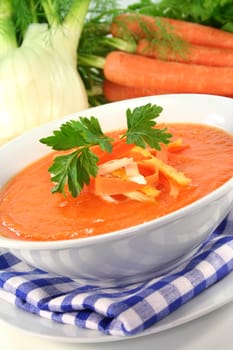 a bowl of carrot soup with fennel and lemon