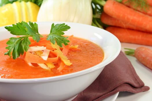 a bowl of carrot soup with fennel and lemon
