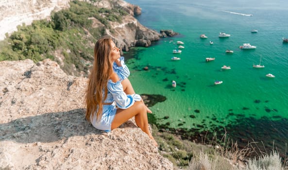 Woman travel sea. Happy woman in a beautiful location poses on a cliff high above the sea, with emerald waters and yachts in the background, while sharing her travel experiences.