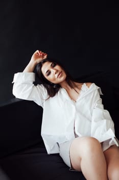 brunette woman on sofa in room