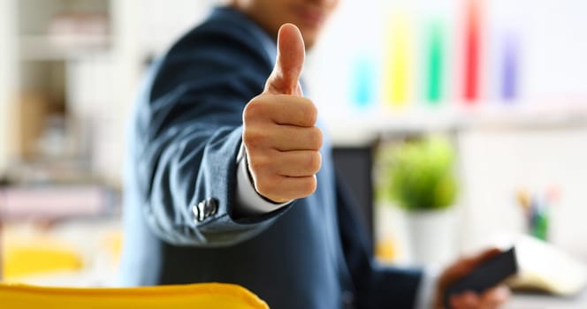 Male arm show OK or confirm during conference in office closeup. High level and quality product offer okay symbol expression perfect mediation solution happy client creative adviser participate