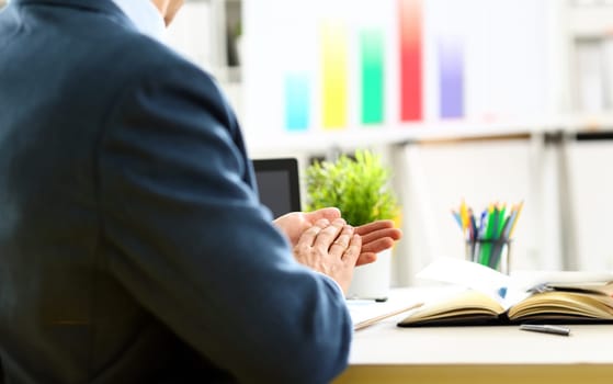 Man in suit clap his arms congrats for successful seminar in office closeup. Thank symbol great lecture job emotion worker introduce colleague negotiation happy birthday win career project idea