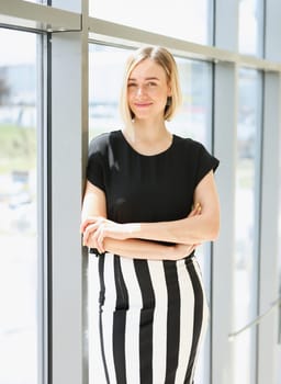 Blonde beauty businesswoman portrait look at camera on window background