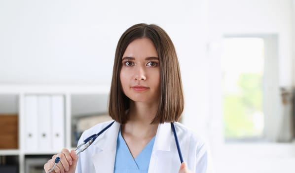 Beautiful smiling female doctor stand in office portrait. Physical and patient disease prevention exam er ward round 911 prescribe remedy healthy lifestyle consultant nurse profession concept