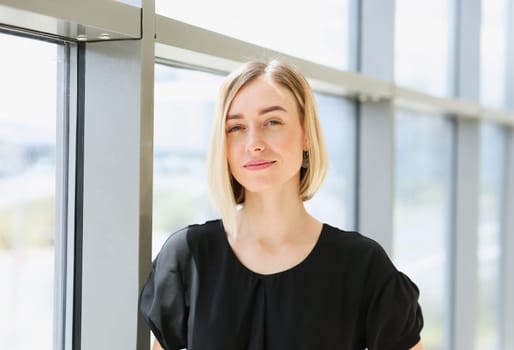 Blonde beauty businesswoman portrait look at camera on window background