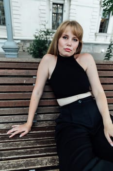 red-haired woman posing at a park bench for a walk