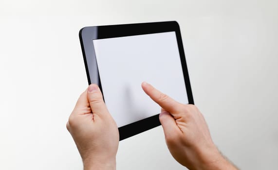 Man hoding black tablet frame in hand isolated on white closeup. Can insert an image image your text for the concept or project development of mobile applications, their advertising for mobile devices