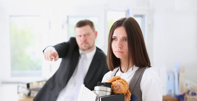 Angry yelling boss point arm to exit dismissing sad worker with stuff box portrait. Bad news pack and carry belongings hopeless human resources staff reduction hr get upset give sack concept