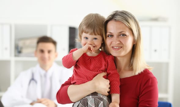 Little child with mother at pediatrician reception. Physical exam cute infant portrait baby aid healthy lifestyle ward round child sickness clinic test high quality and trust concept