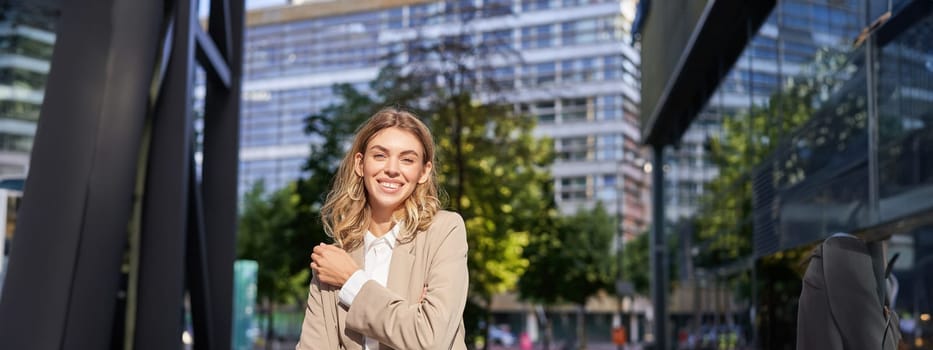 Successful working woman, office manager in suit, cross arms on chest, looking with confidence. Corporate people concept