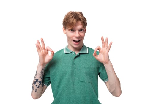 young surprised european man with red hair and stylish hairstyle looks wide open eyes.