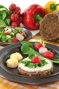 a slice of bread topped with cream cheese and fresh wild garlic