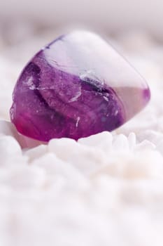 Natural stone amethyst shines in beautiful colors on a white background