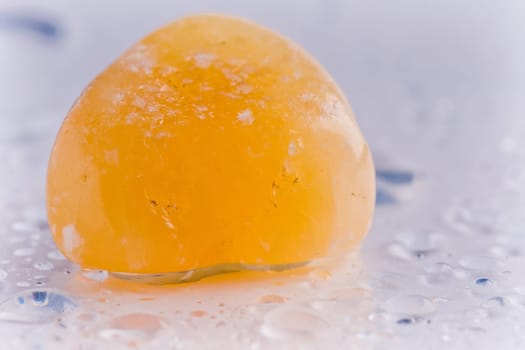 Natural stone carnelian shines in beautiful colors on a white background