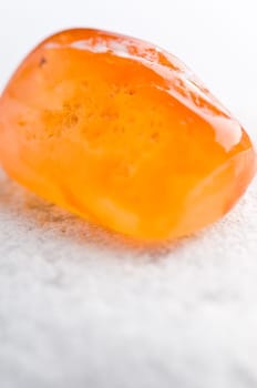 Natural stone carnelian shines in beautiful colors on a white background