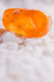 Natural stone carnelian shines in beautiful colors on a white background